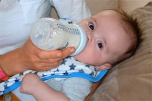 baby biting bottle teat