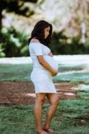 Pregnant woman grass bare spot
