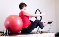 Pregnant woman stretching to prepare for birth