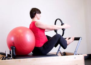 Pregnant woman stretching to prepare for birth