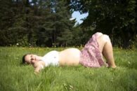 Trees flowers grass pregnant woman sky