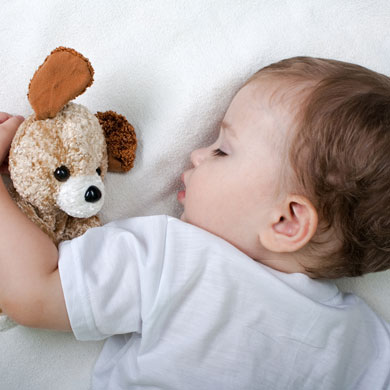 baby sleeping with teddy