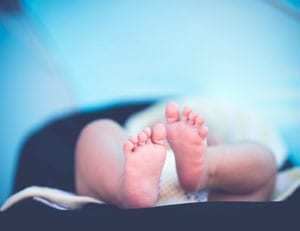 Baby feet blue background