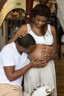 Man woman pregnant kissing stomach