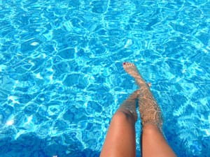 Relaxing pool legs reflections
