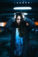 Woman headache parking garage blue