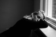 Woman resting window sill bricks