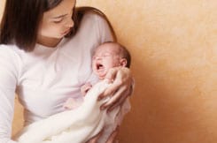 Woman holding baby with colic