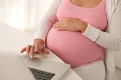 Pregnant woman on a laptop