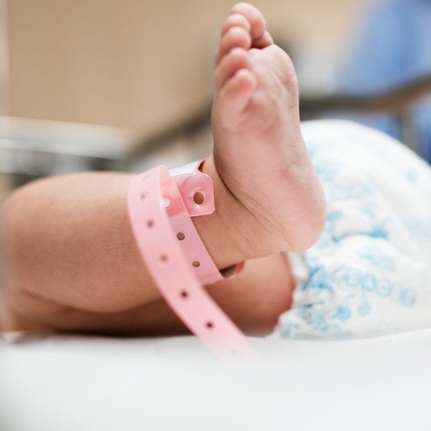 breastfeeding newborn baby foot in hospital