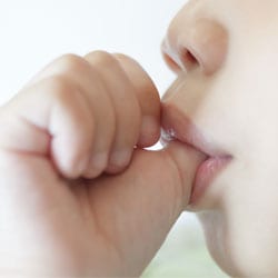 child sicking thumb at nighttime before bed