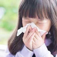 little girl blowing nose to prepare for cold season