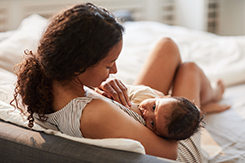 Young mother nursing baby on a cheerful morning.