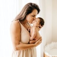 postpartum woman holding newborn